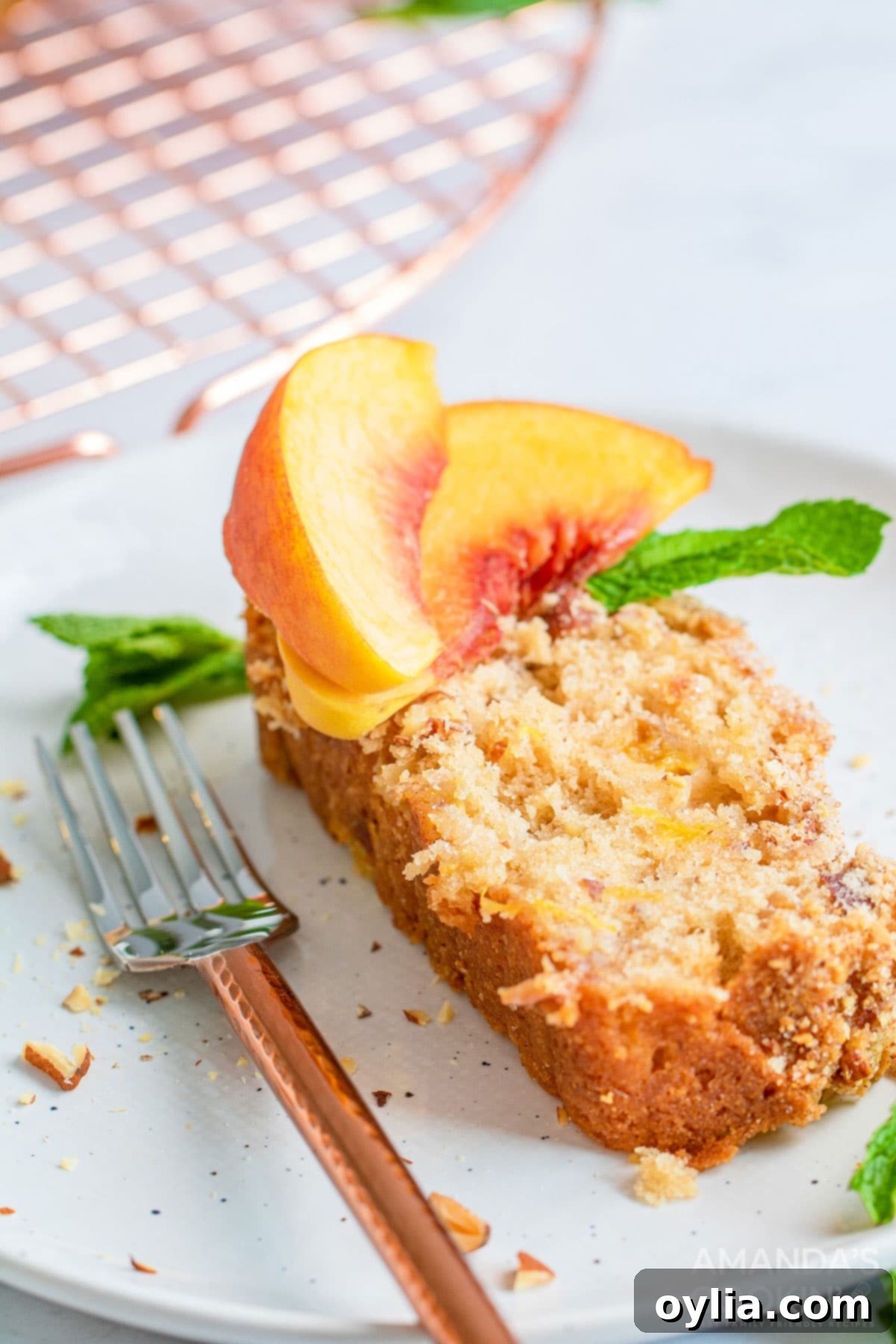 slice of peach bread on a plate with a fork