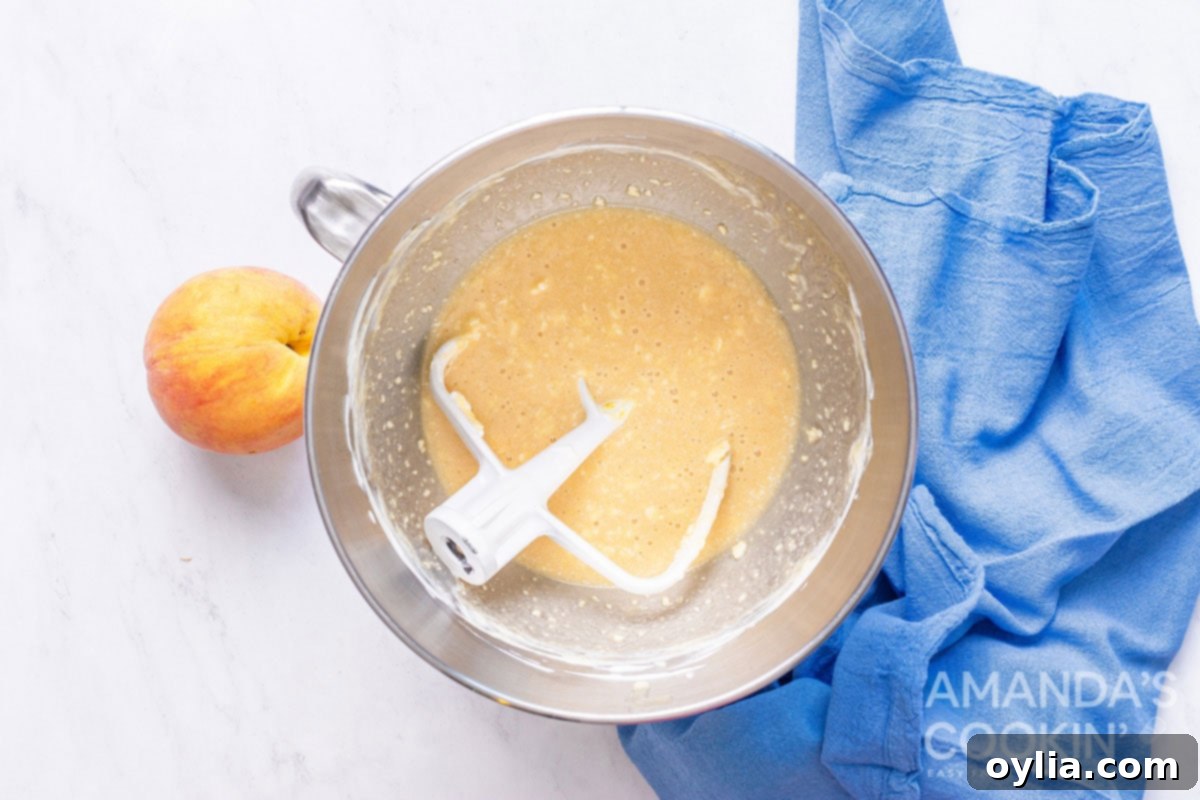 peach bread batter in bowl with paddle attachment