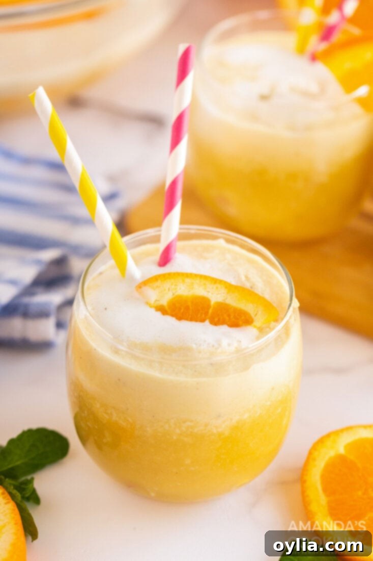 With only four ingredients you can make this creamy, dreamy, vanilla orange punch. Whether it's in the fall, summer, or spring, it's delicious year-round! glass of orange punch with straws