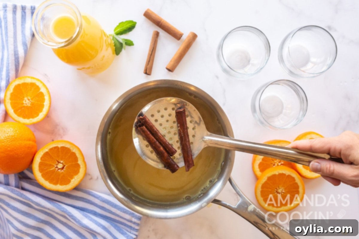 straining cinnamon sticks from saucepan