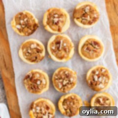 Mini Pecan Pie Perfection 15 pecan tassies on a wood cookie boards