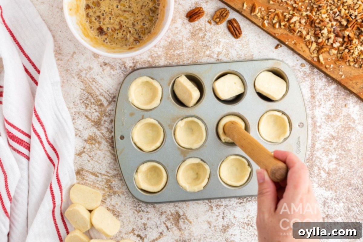 pressing dough in muffin tin