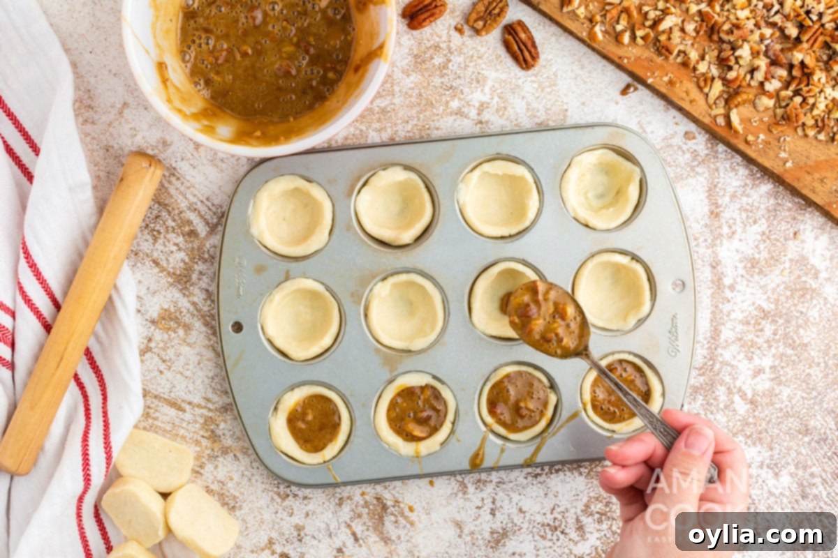 spooning filling into dough in muffin tin