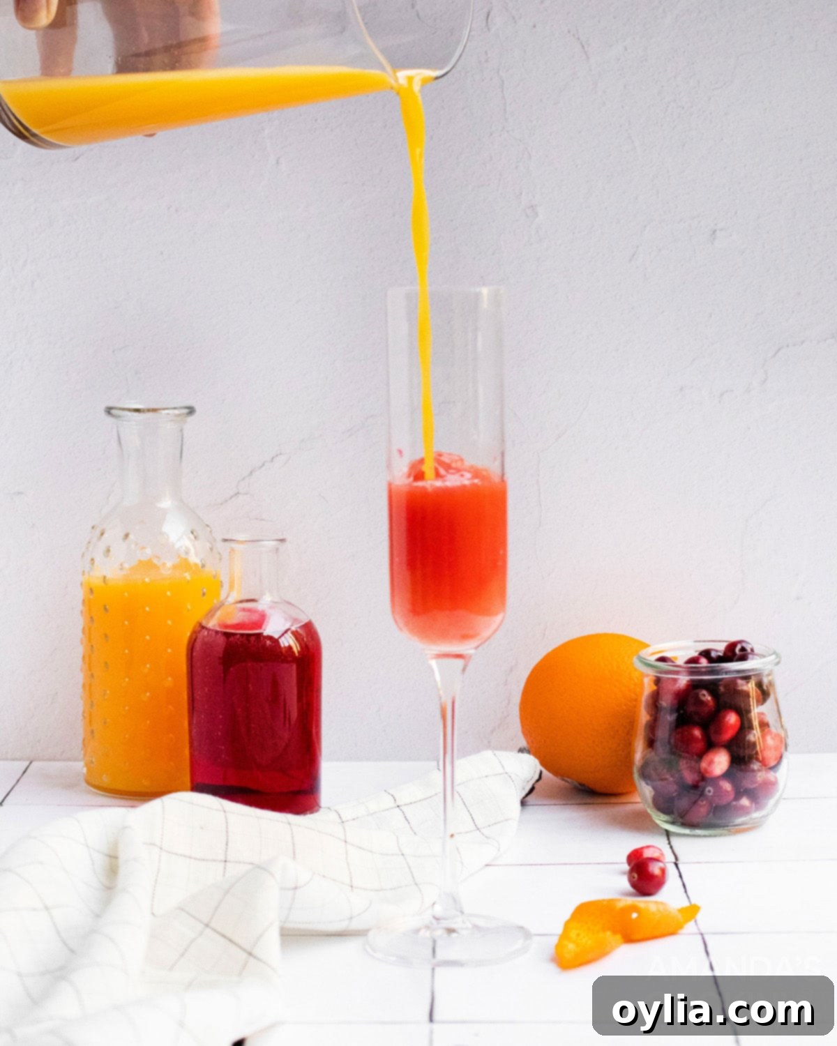 pouring orange juice into a chamagne flute