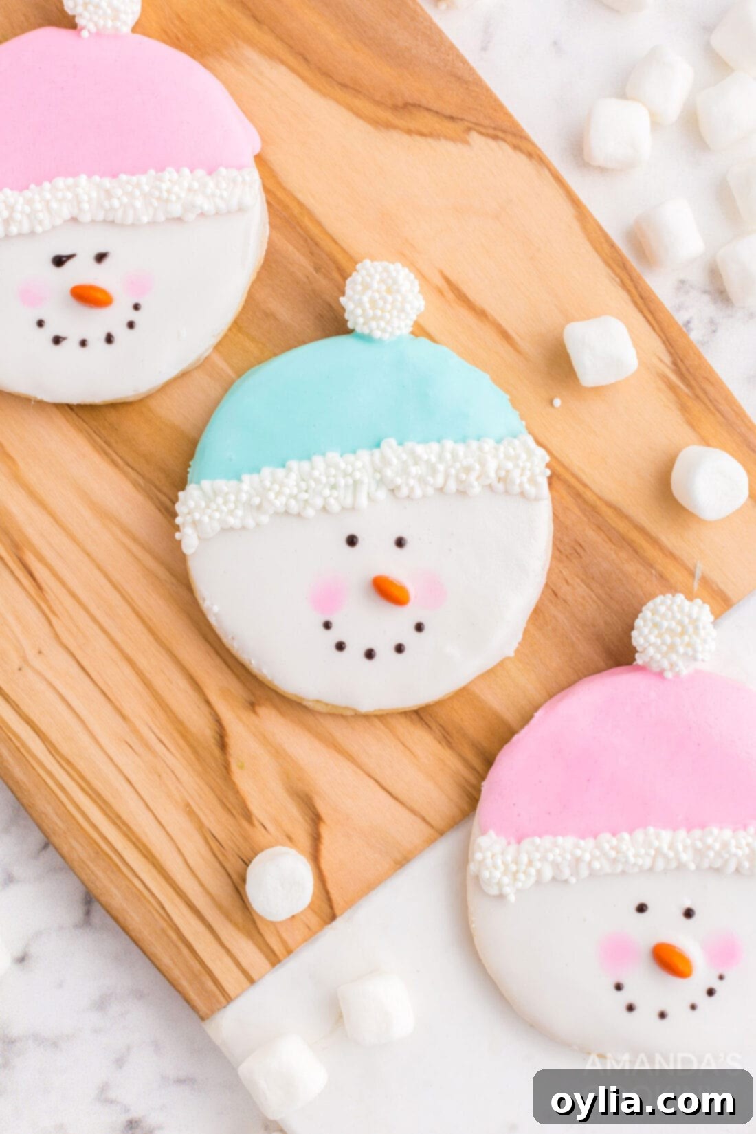 snowman cookies on cutting board