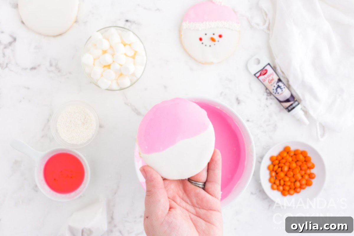 a cookie iced with white and pink