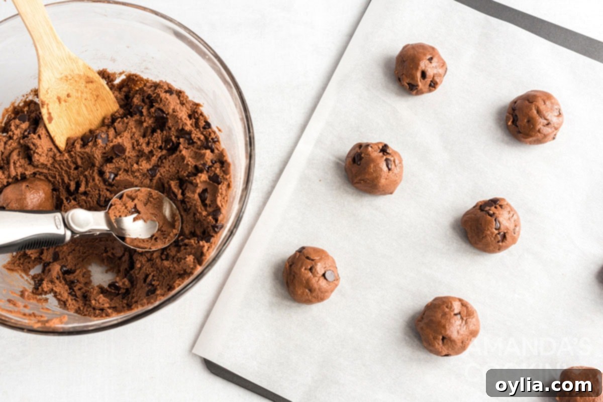 Cookie dough balls neatly arranged on a baking sheet