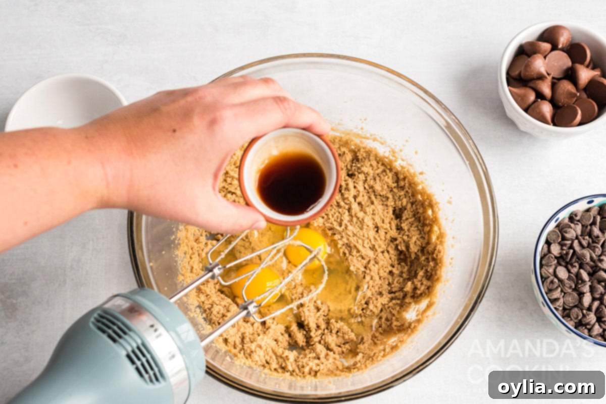 Adding vanilla to eggs and sugar mixture for cookie dough