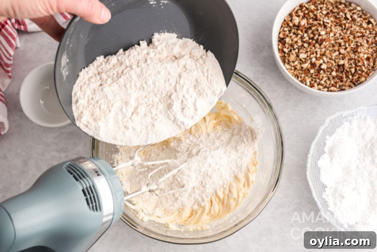 adding flour to bowl