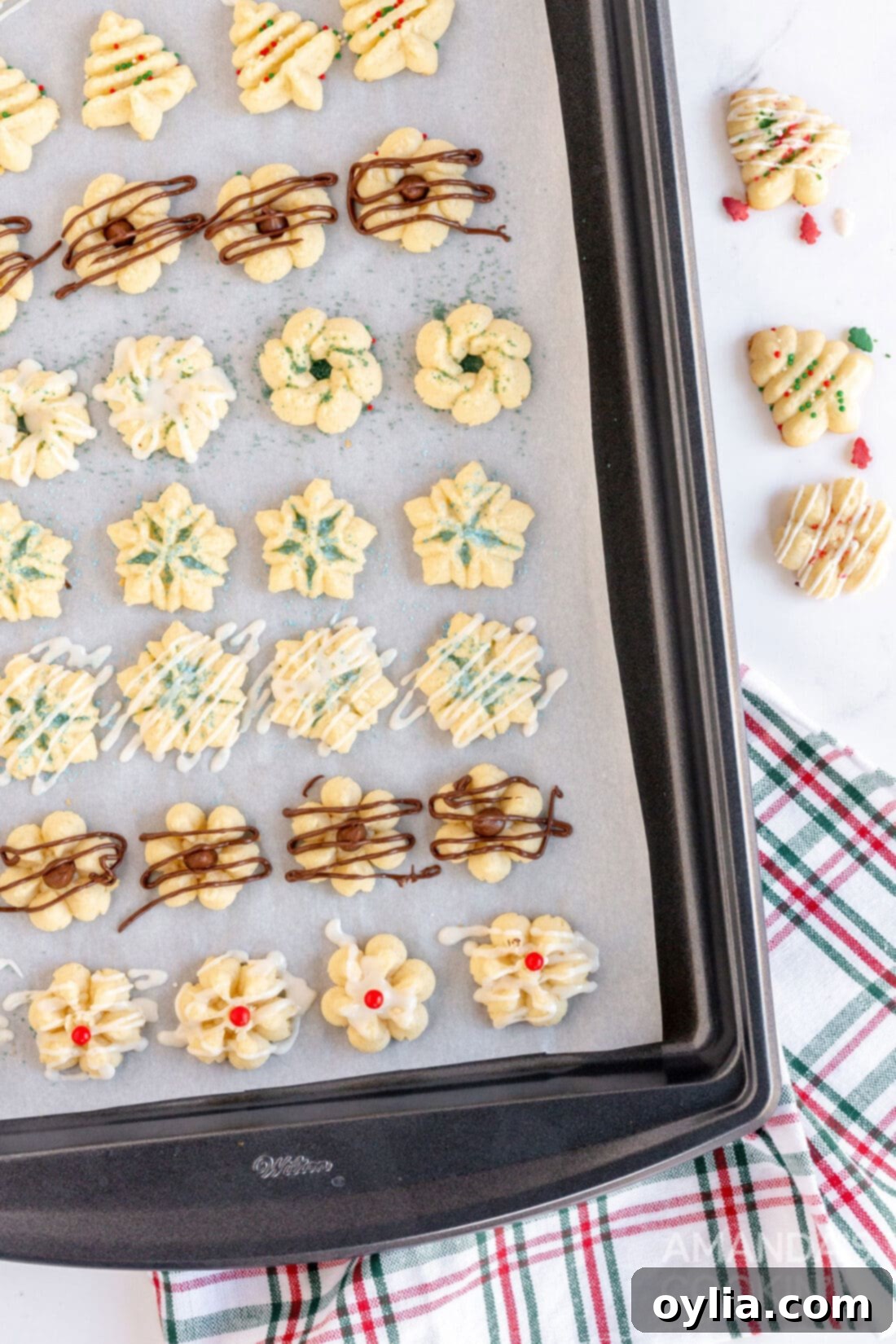 baking sheet filled with raw spritz cookies before baking