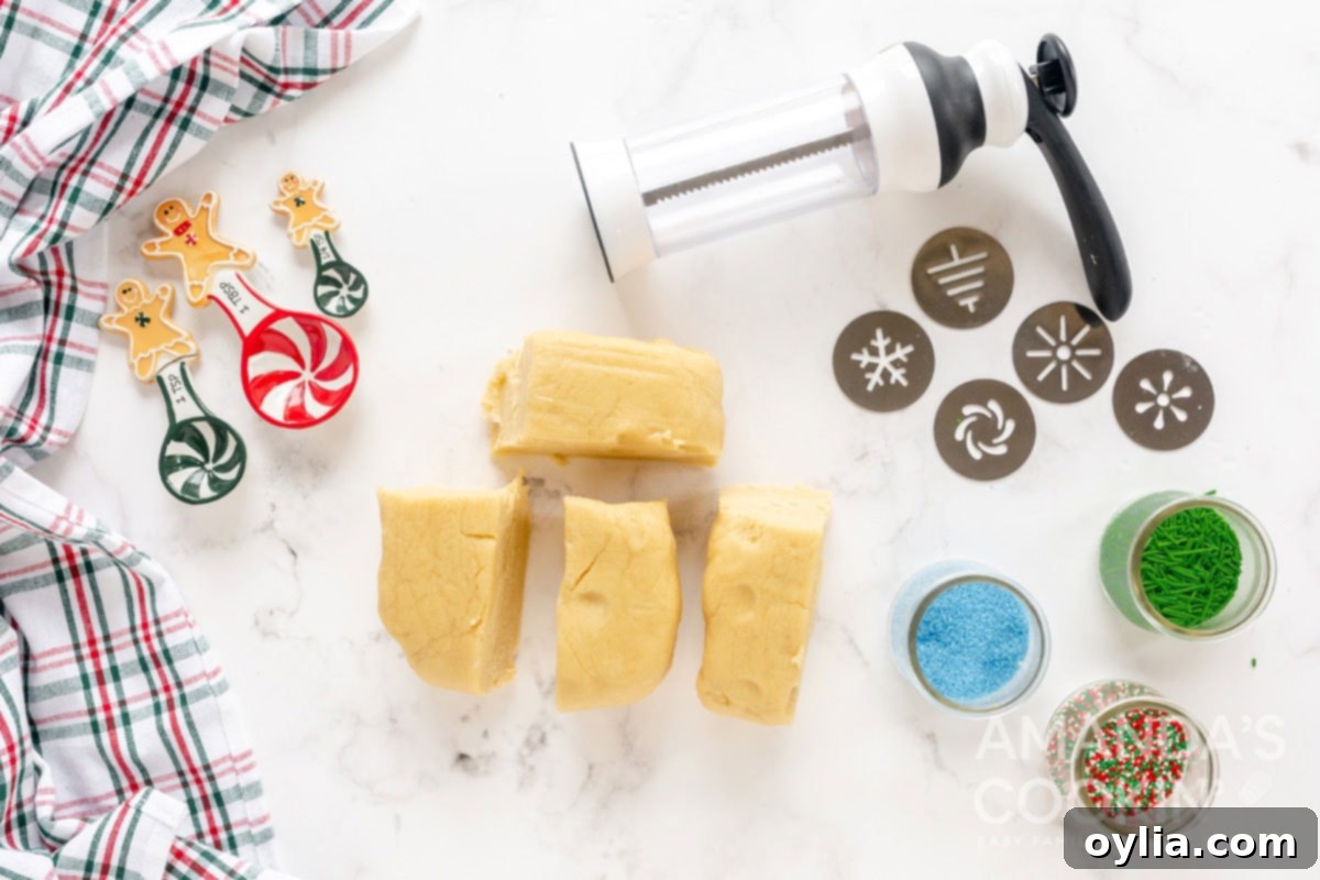 cookie dough cut into pieces, ready for the cookie press