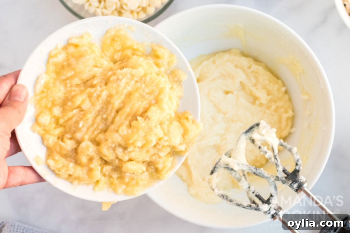 Mashed banana being added to cookie dough