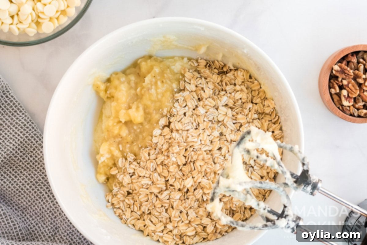 Quick oats being mixed into cookie dough