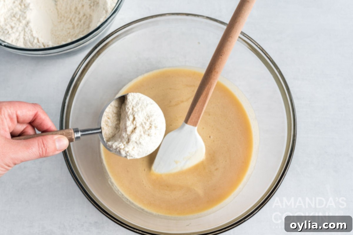 Adding flour mixture to the wet cookie dough