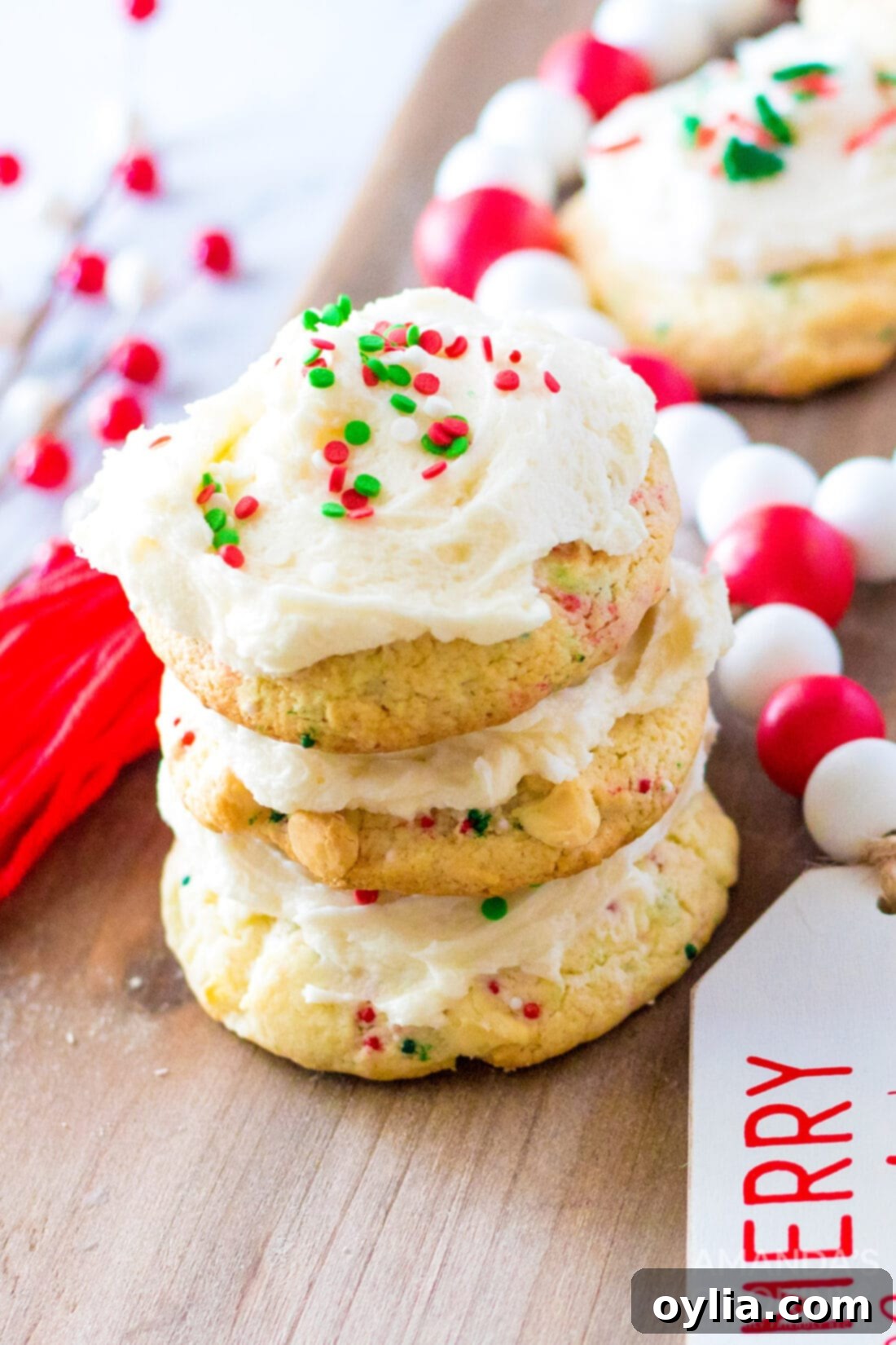 Stack of frosted confetti cake mix cookies with red and green sprinkles, perfect for Christmas