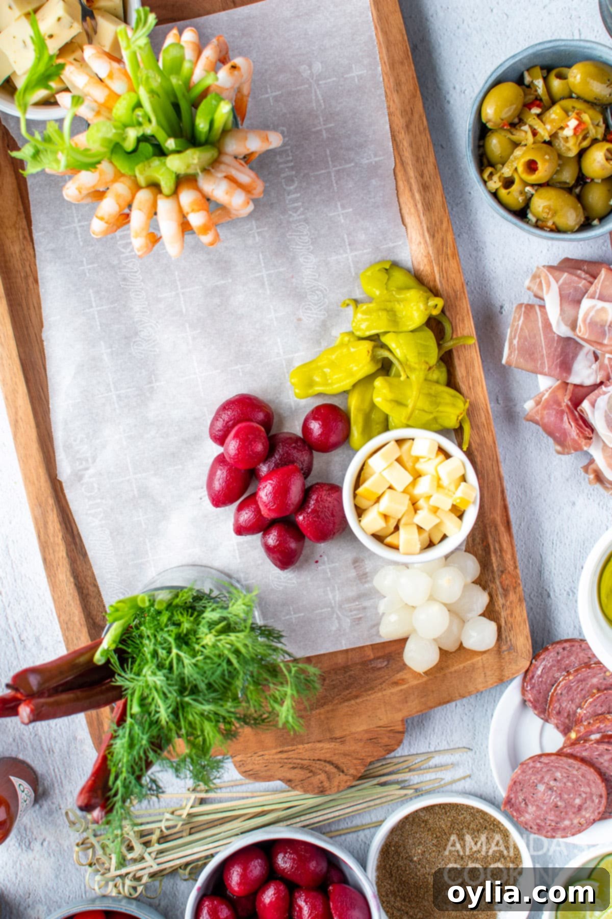 Step-by-step image showing initial placement of cups and bowls on a charcuterie board