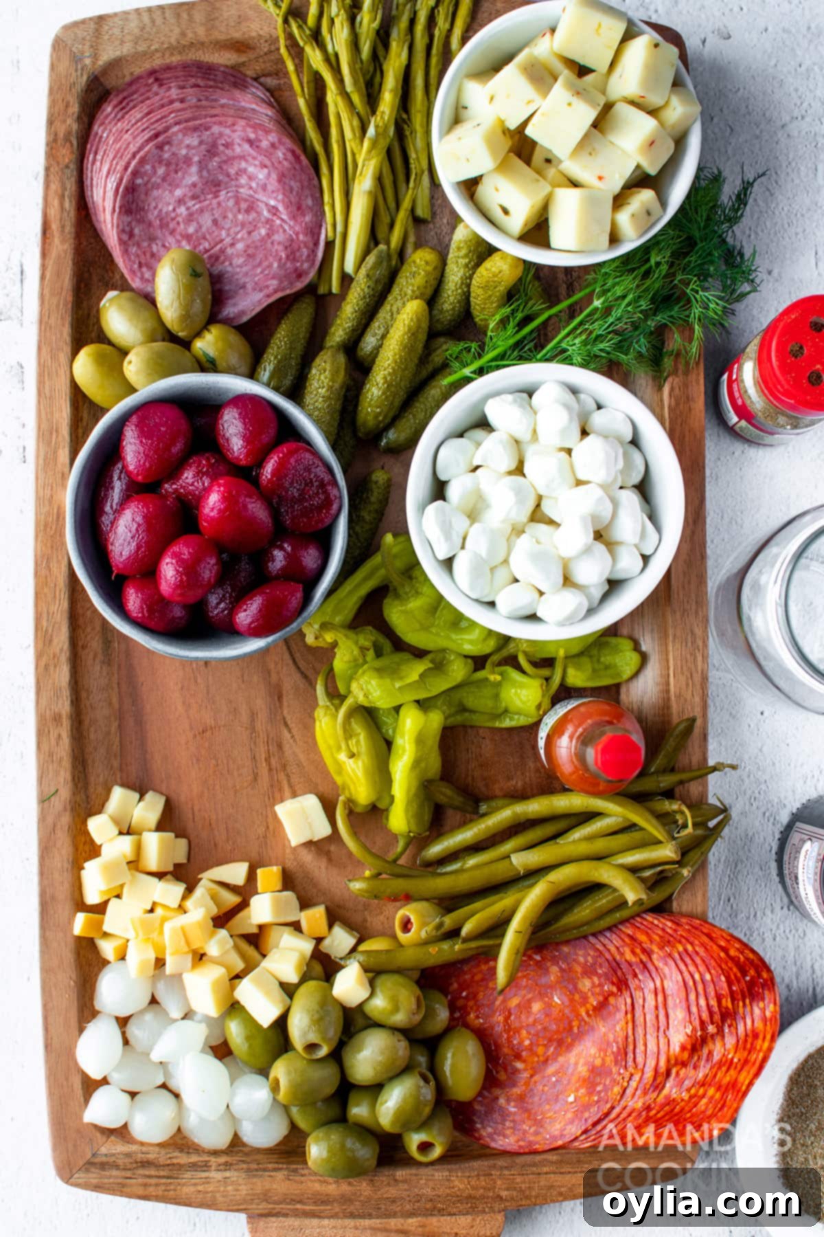 Arranging various Bloody Mary garnishes on a charcuterie board