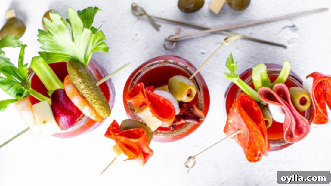 Overhead photo of two Bloody Marys with a variety of garnishes
