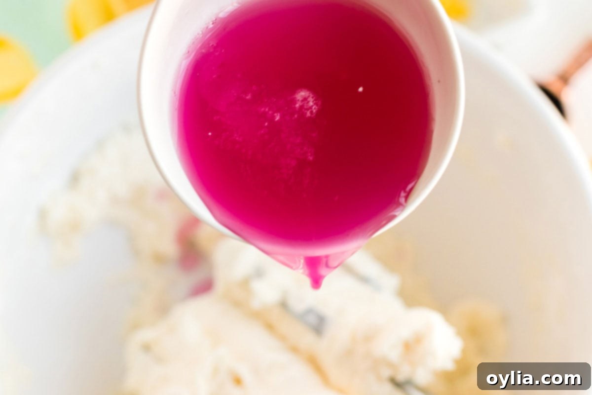 Sparkling Pink Lemonade Cake 11 adding pink lemonade concentrate to a bowl of cake batter