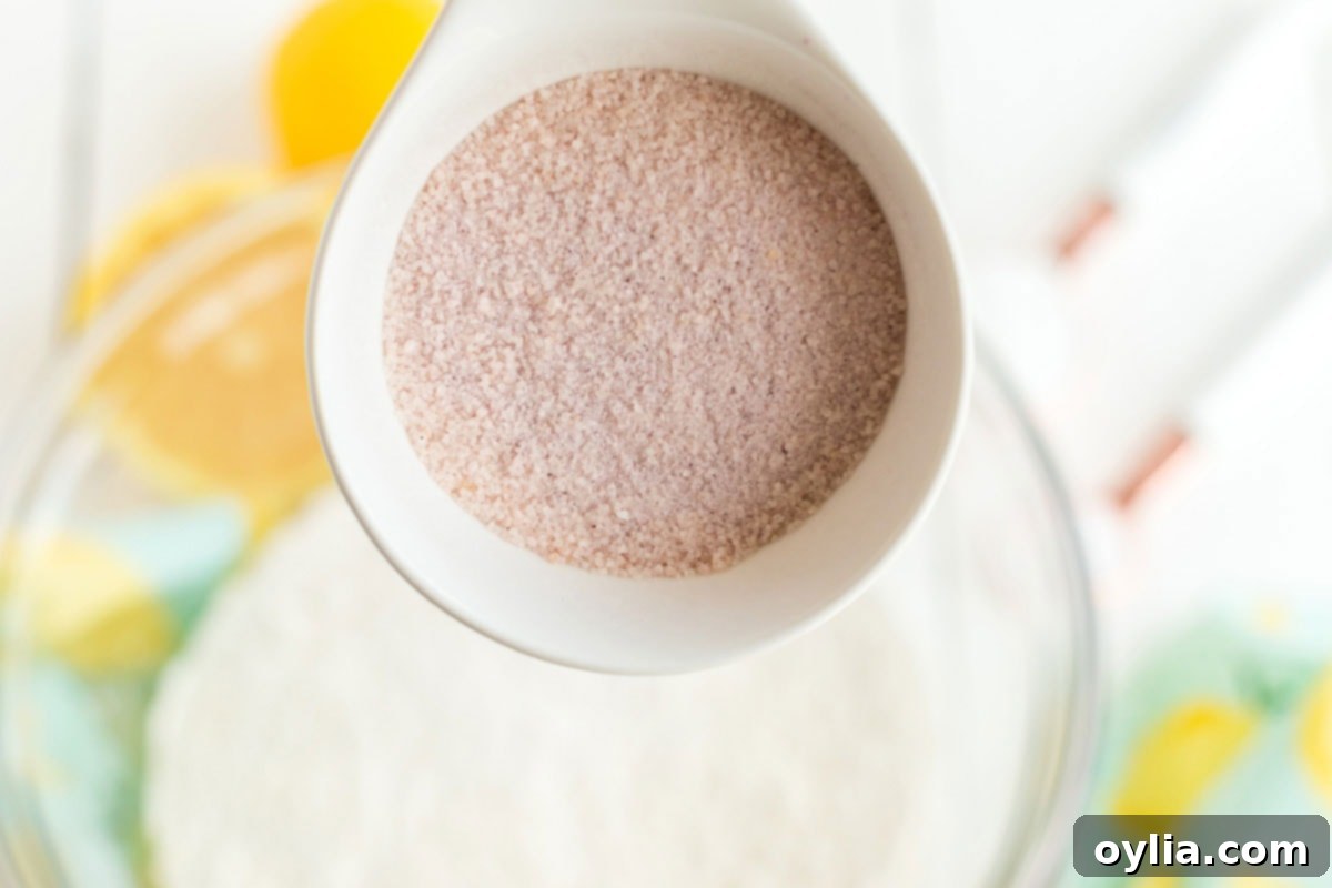 Sparkling Pink Lemonade Cake 4 adding pink lemonade powder to bowl