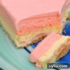 Frosted Orange Dream Bars 2 A close up photo of a slice of frosty orange dream square on a plate.