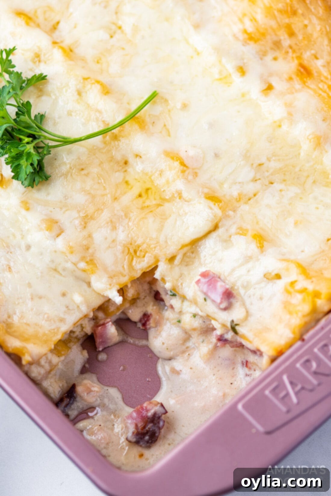 Creamy Chicken Cordon Bleu Lasagna 11 A freshly baked pan of Chicken Cordon Bleu Lasagna with one delicious slice removed, ready to serve.
