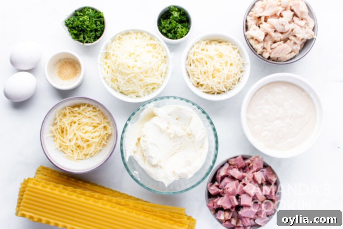 Creamy Chicken Cordon Bleu Lasagna 4 Labeled ingredients laid out on a table for making Chicken Cordon Bleu Lasagna, including cheeses, sauces, and proteins.
