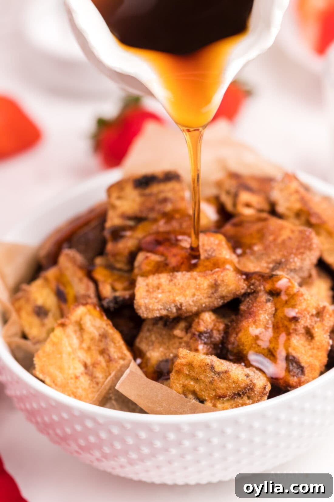 pouring syrup over Air Fryer French Toast Bites