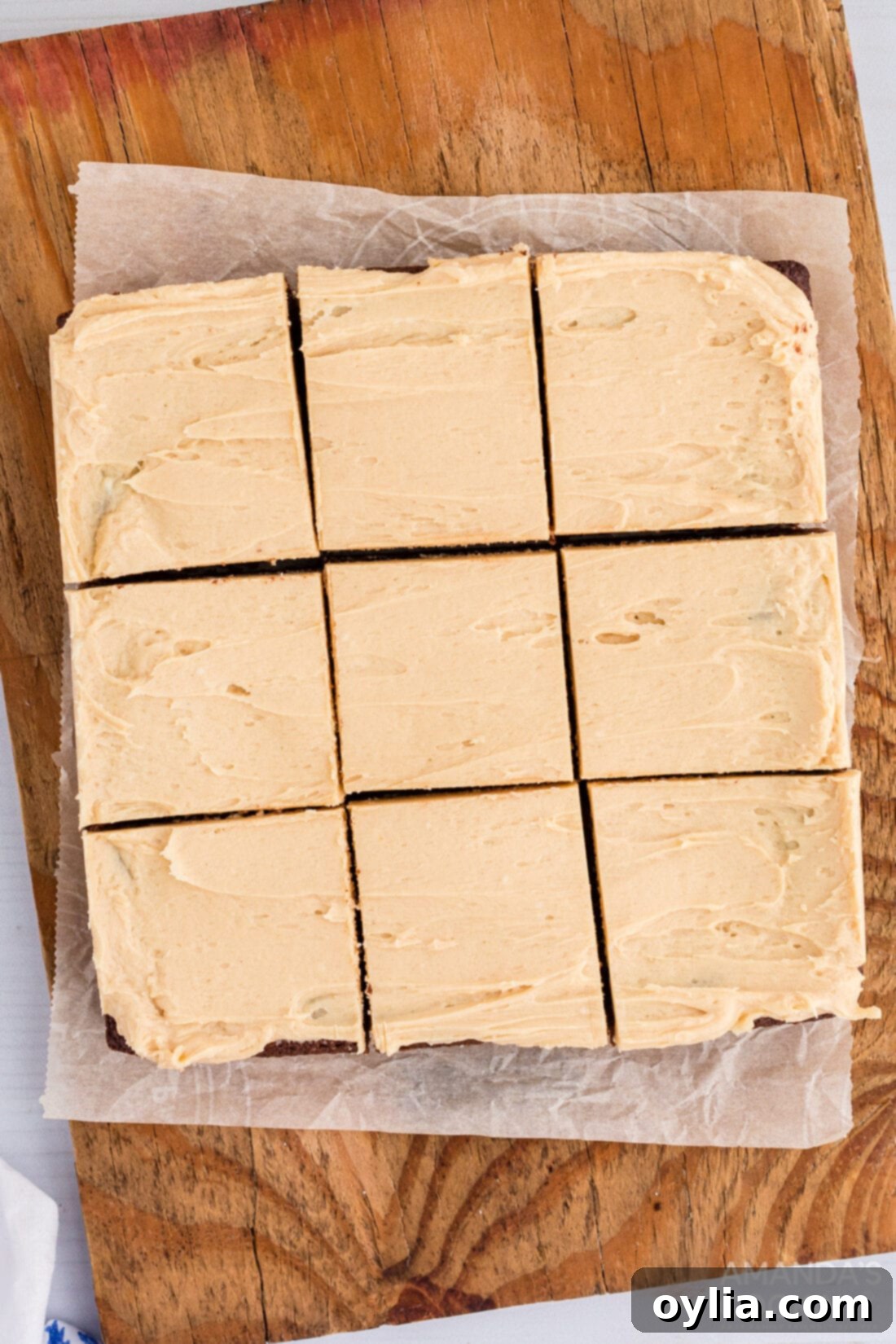 Perfectly cut fudge brownie squares generously topped with peanut butter frosting