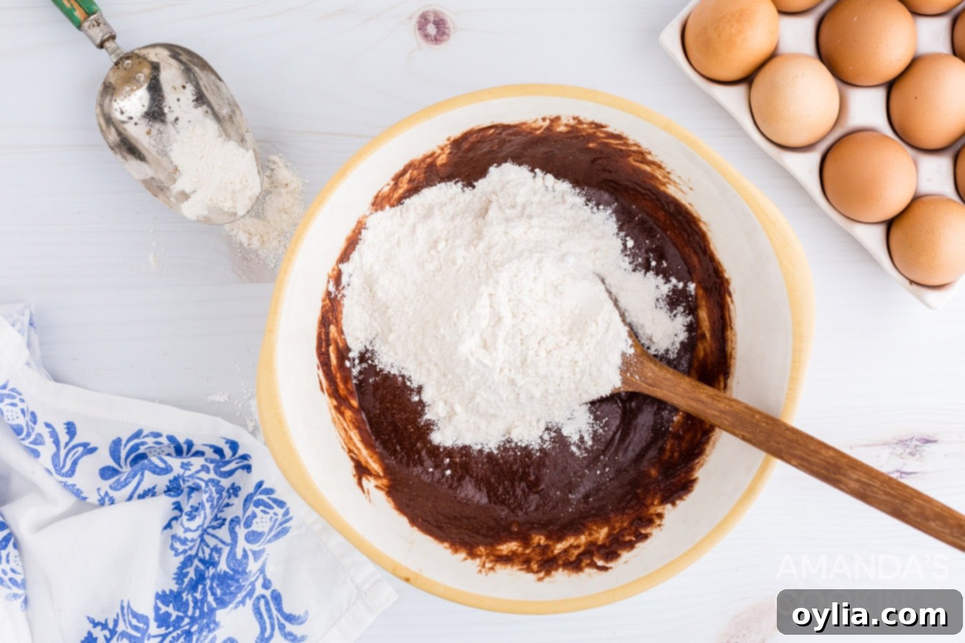 Gently folding flour and baking soda into the brownie batter