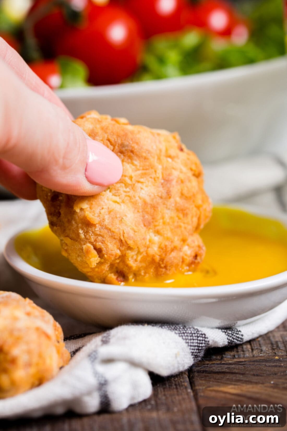 dipping chicken nugget into mustard