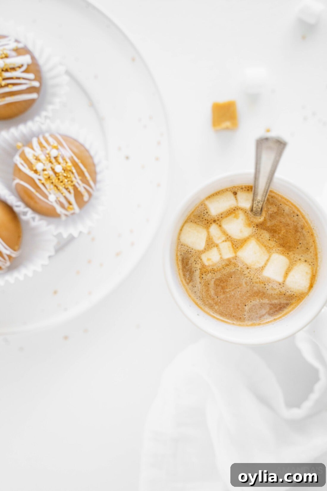 A close-up of a steaming mug of caramel hot cocoa, topped with whipped cream and a caramel drizzle, looking inviting and warm.