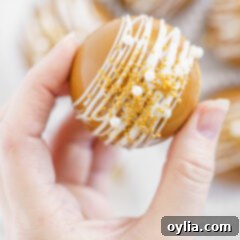 woman holding a caramel hot cocoa bomb