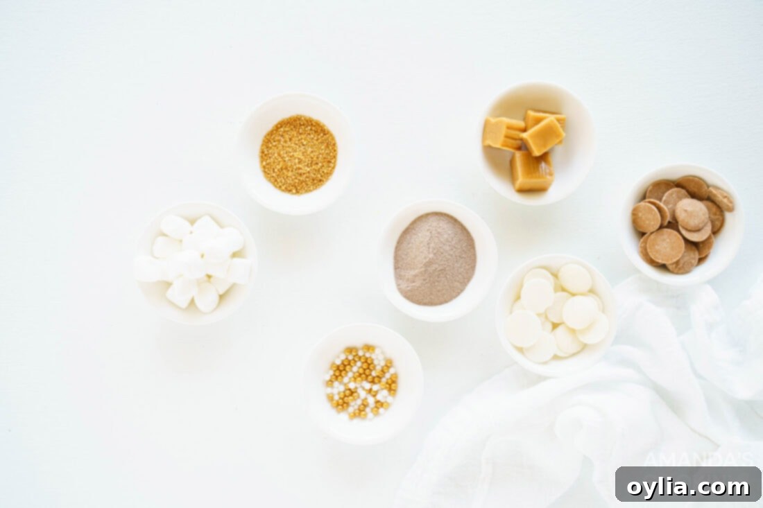 A flat lay of ingredients laid out on a surface, including caramel candy melts, hot cocoa mix, mini marshmallows, and soft caramels, ready for making hot cocoa bombs.