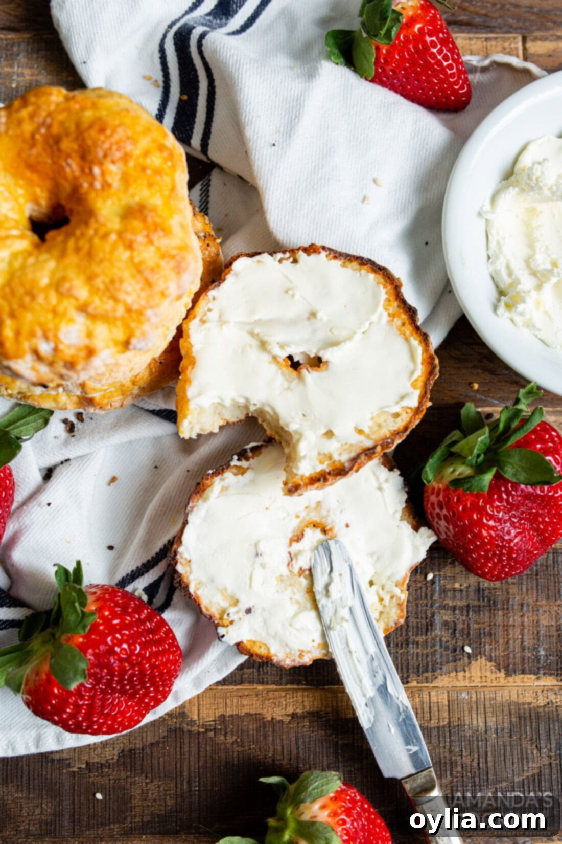 Perfect Air Fryer Bagels 3 Bagels topped with cream cheese and chives, a classic combination.