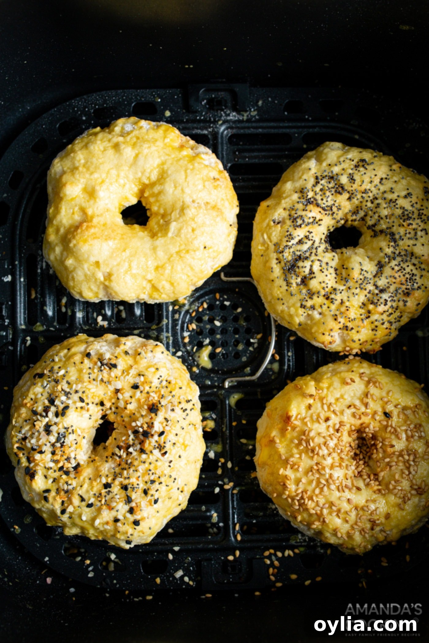 Air fryer bagels brushed with egg wash and ready for final cooking.