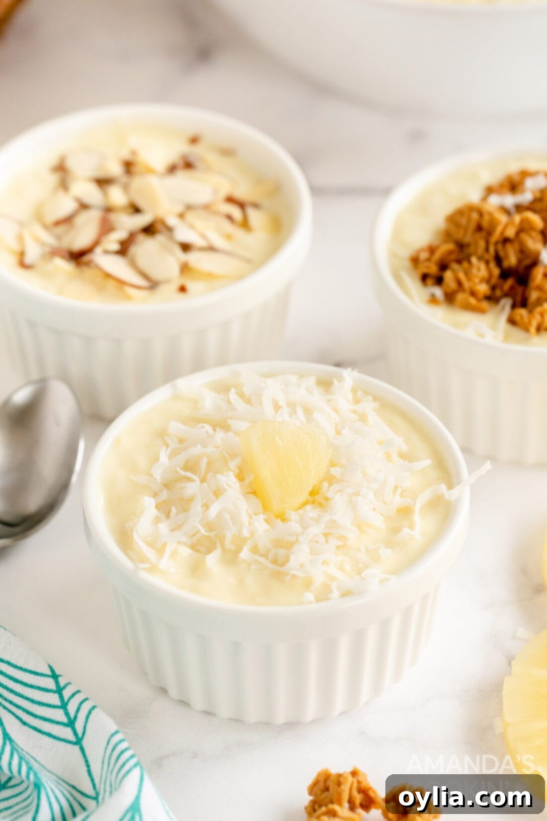 Tropical Yogurt Delight 3 pineapple yogurt dessert with different toppings like coconut and berries