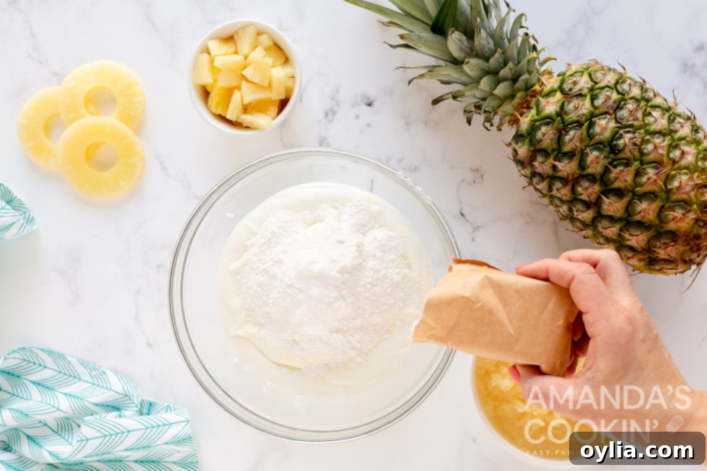 adding dry pudding mix to bowl of Greek yogurt