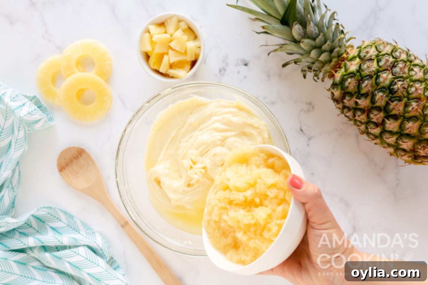 adding crushed pineapple with juice to yogurt and pudding mix