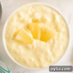 Tropical Yogurt Delight 9 pineapple yogurt dessert in a ramekin with a spoon