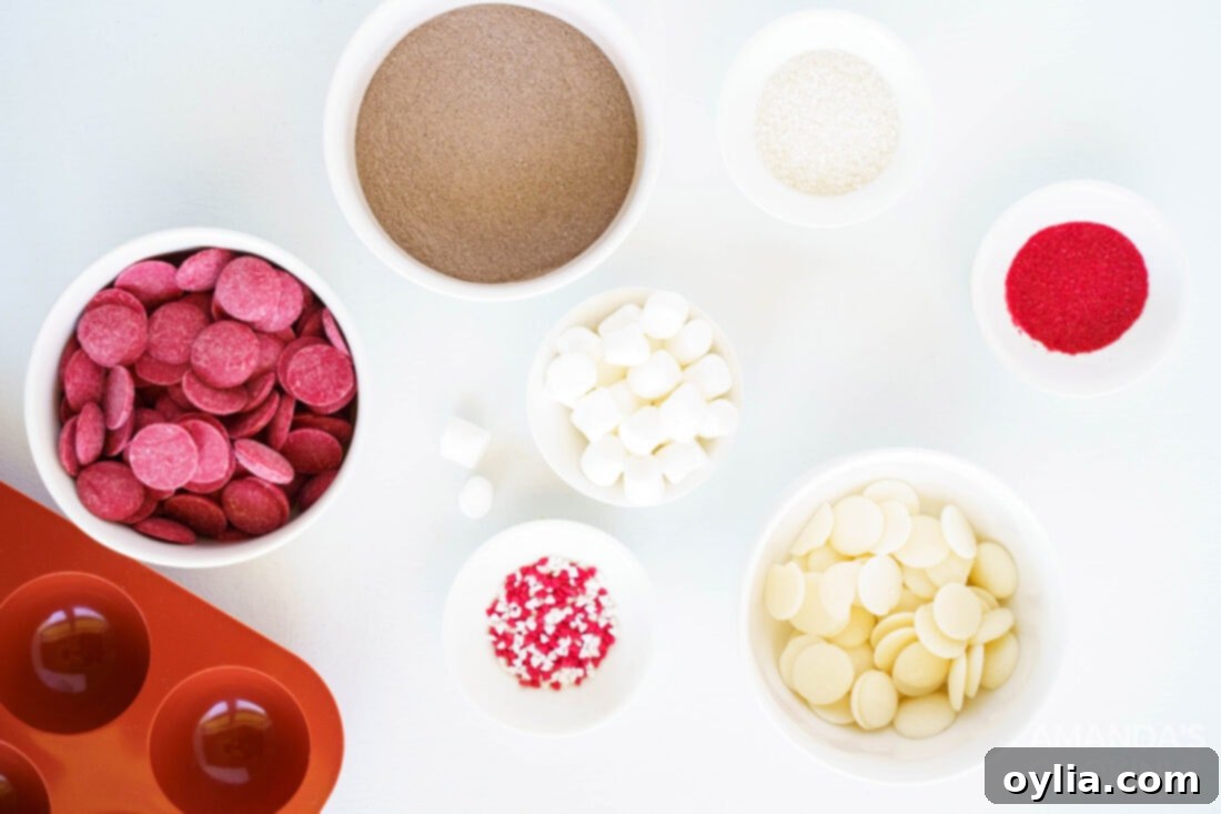 A flat lay photograph showcasing all the ingredients required for making red velvet hot cocoa bombs, neatly arranged.