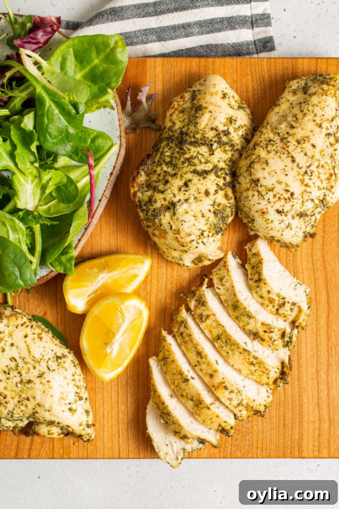 chicken breasts on a cutting board, sliced and ready to serve