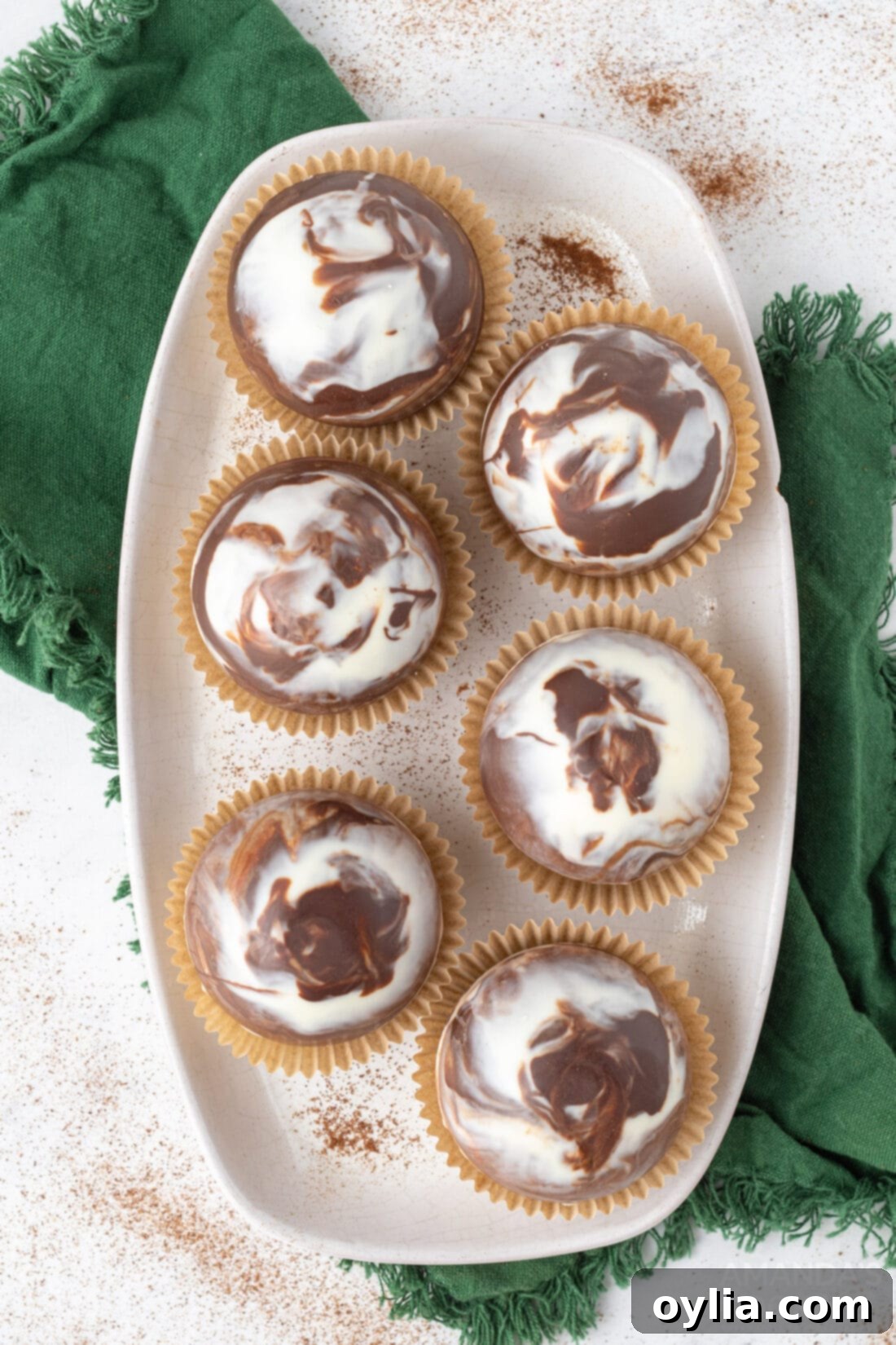 A tray filled with freshly made, beautifully marbled mocha hot cocoa bombs, ready to be enjoyed or gifted.