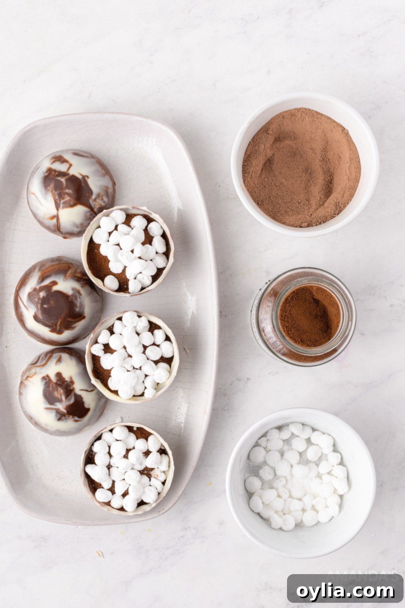 Espresso powder and mini marshmallows are added on top of the hot cocoa mix within the chocolate half-spheres.