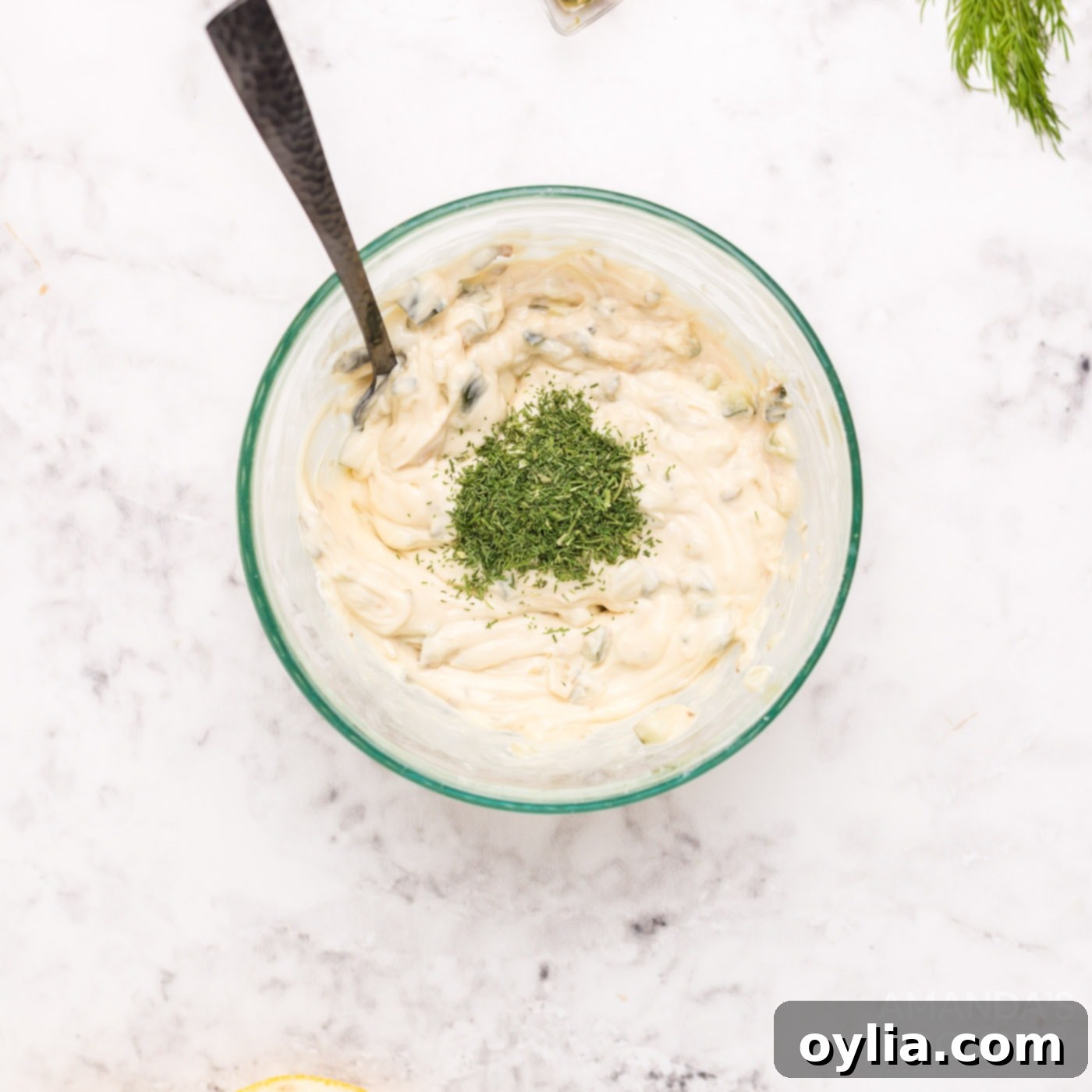 Ingredients for tartar sauce in a bowl, ready to be mixed