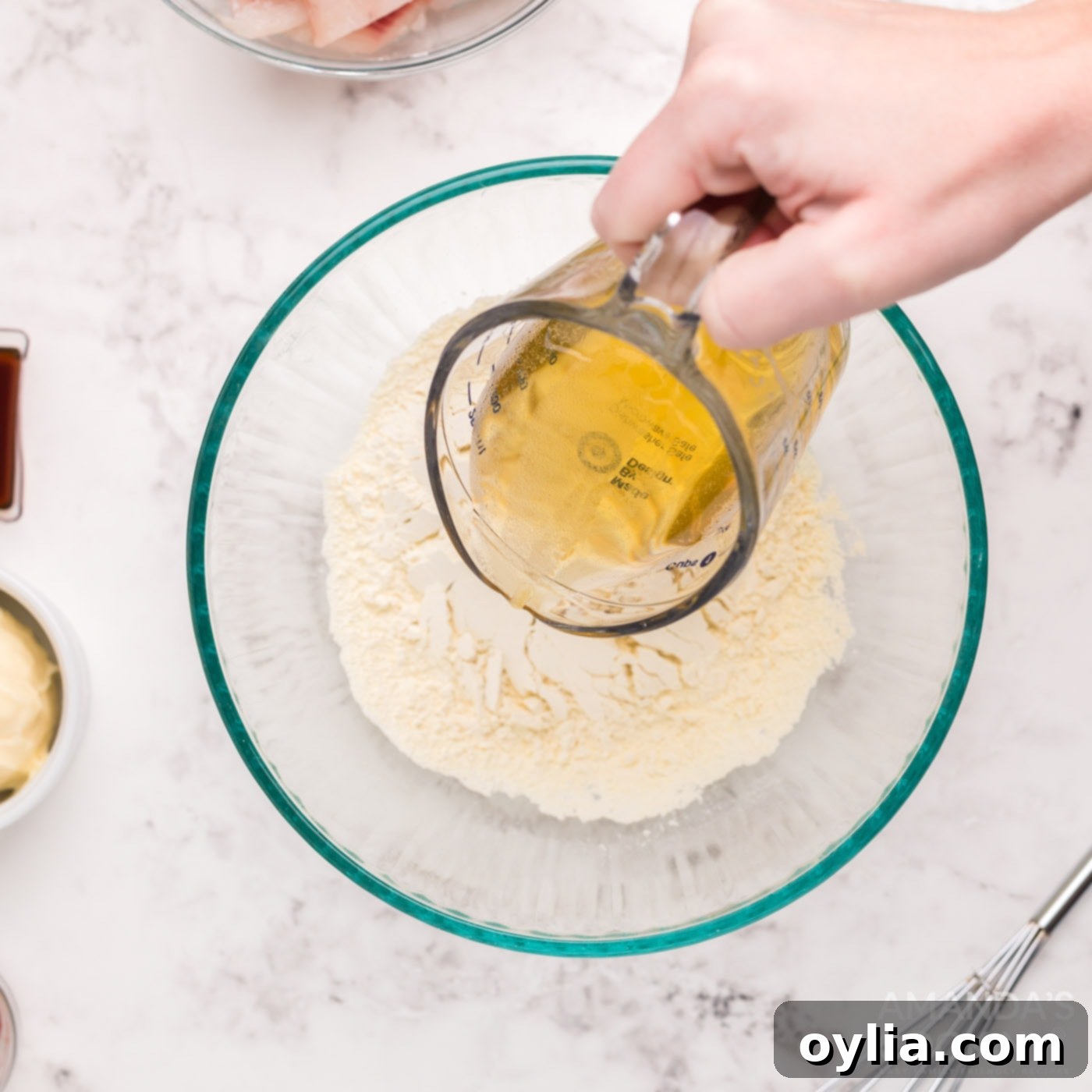 Pouring beer into the flour mixture to make the batter