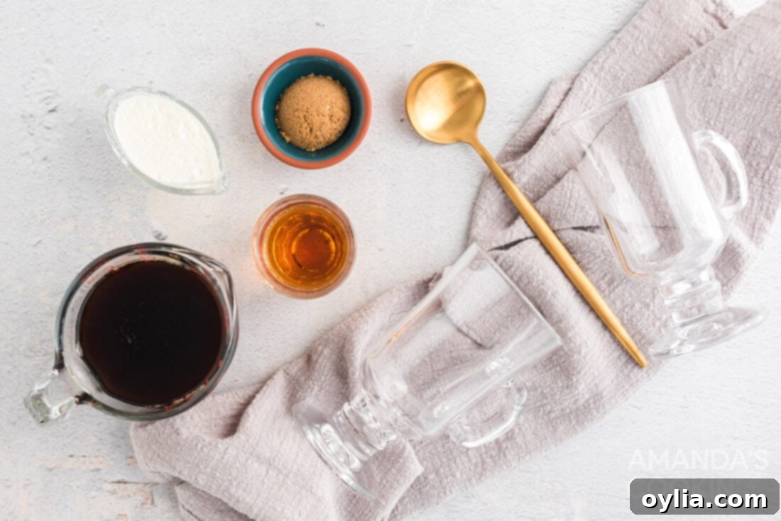 A flat lay photograph displaying all the ingredients needed to make an Irish coffee: coffee beans, a cup of brewed coffee, a bottle of Irish whiskey, brown sugar, and heavy cream.