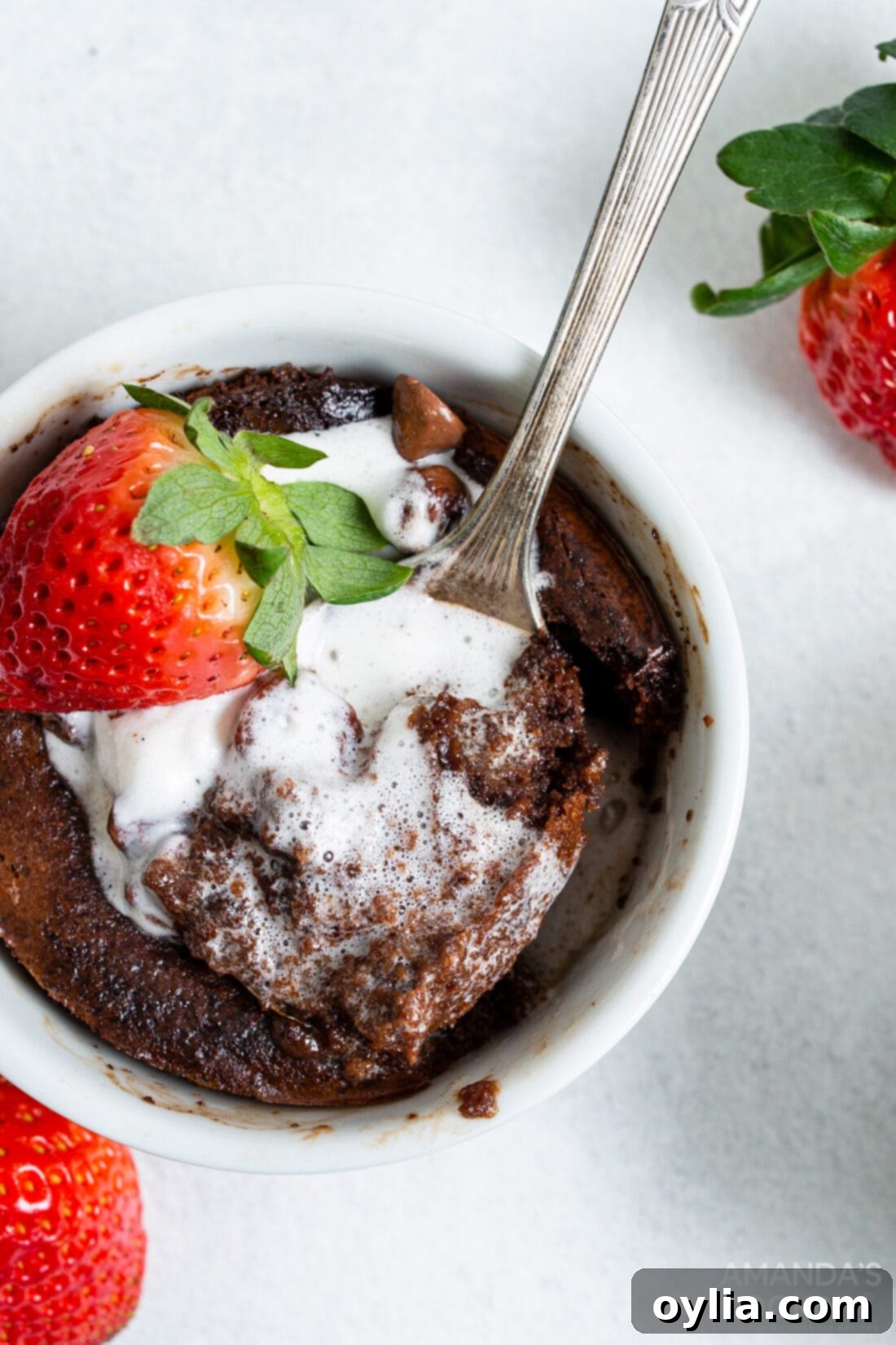 air fryer brownie in a ramekin with ice cream and strawberries