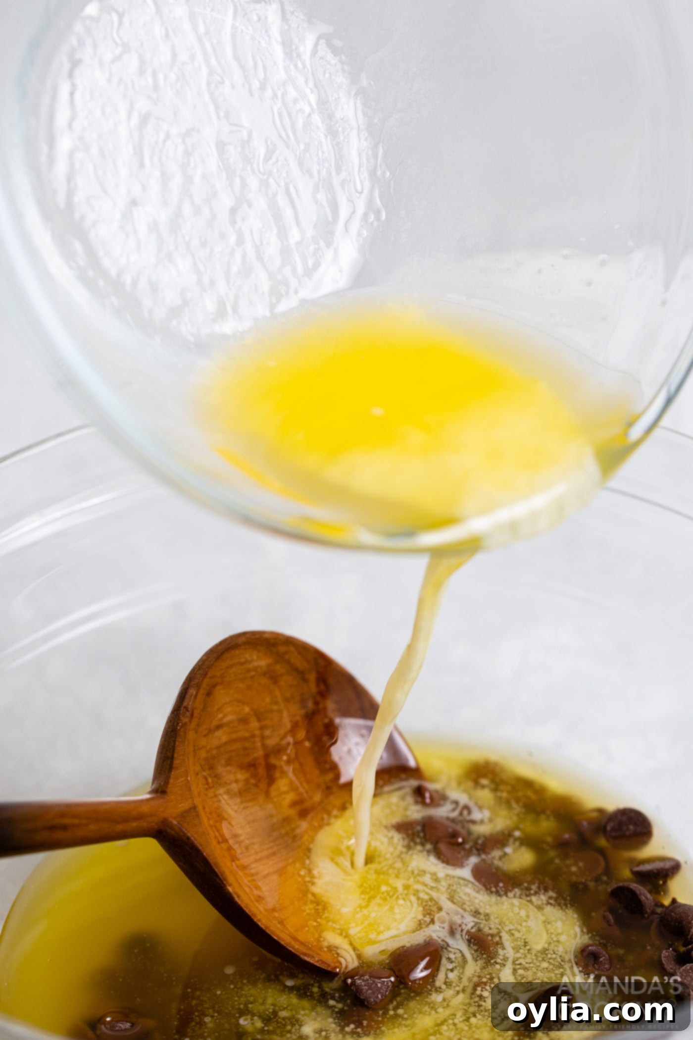 pouring melted butter over chocolate chips