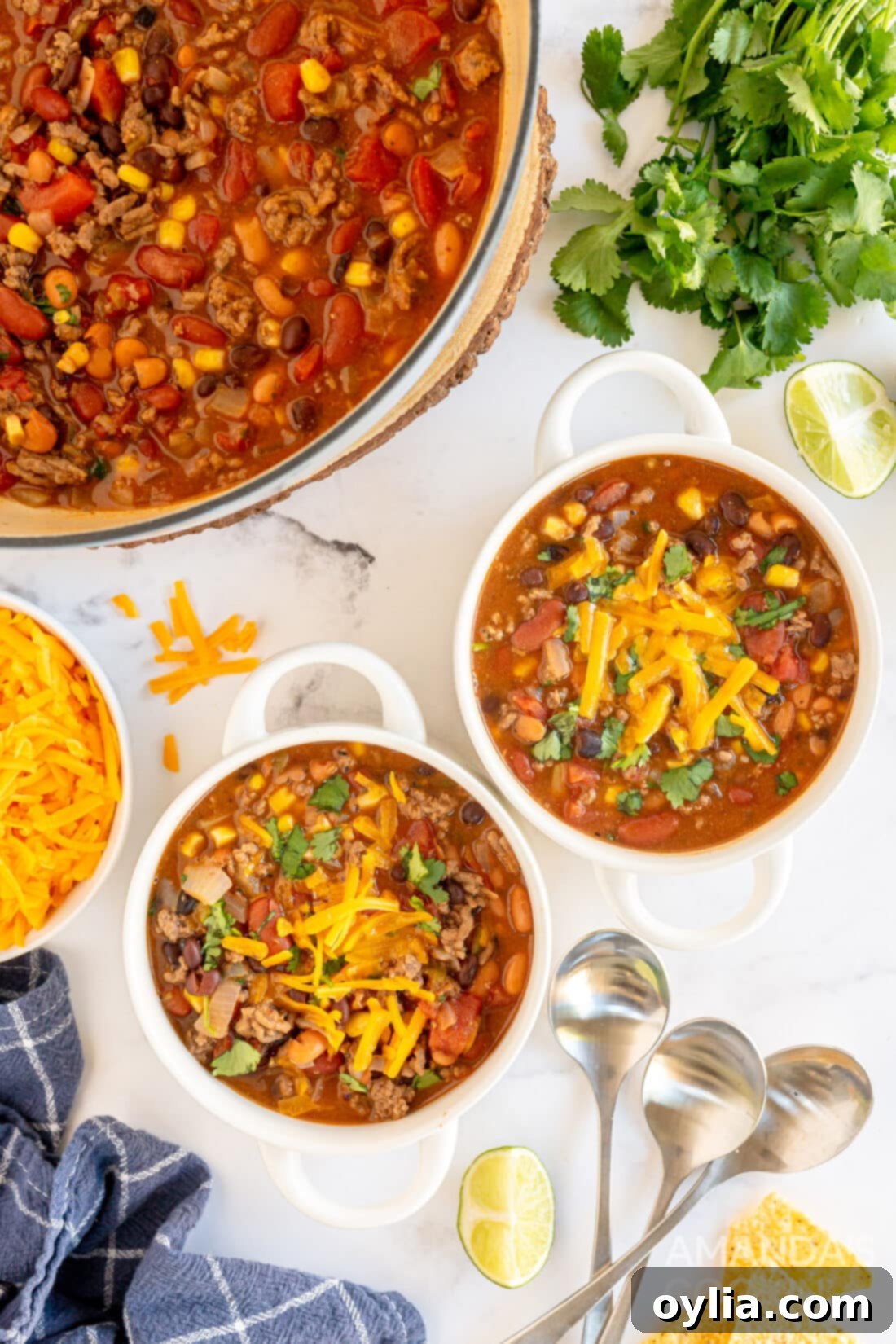 Ultimate Taco Soup 2 Two bowls of homemade taco soup, garnished with shredded cheese and cilantro, ready to be enjoyed.